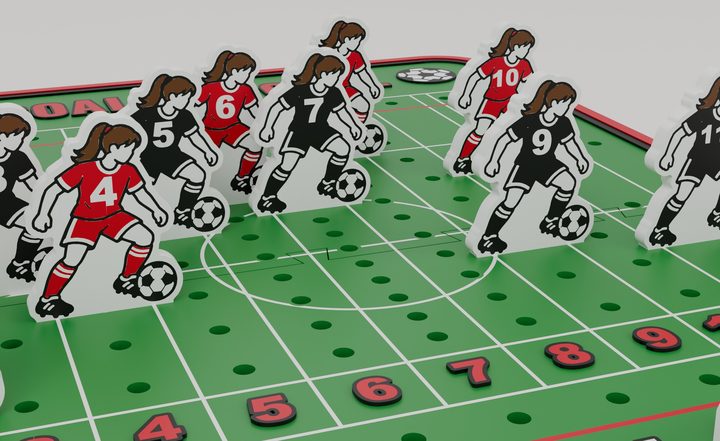 Close-up of the red and black soccer player pieces on the field board